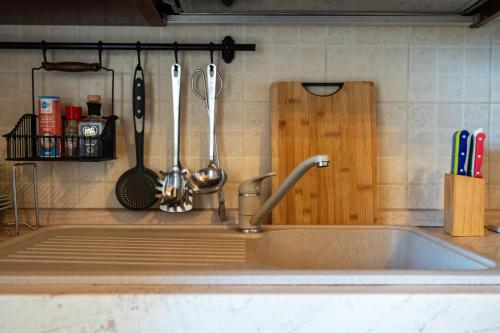 a kitchen sink with utensils on a counter at Villette di Contignano in Radicofani