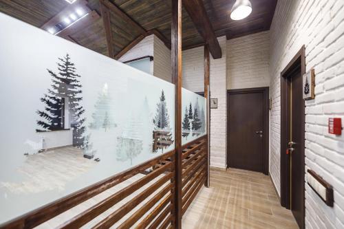 a hallway with a large picture of a christmas tree on the wall at Guest House El in Chesnokovka