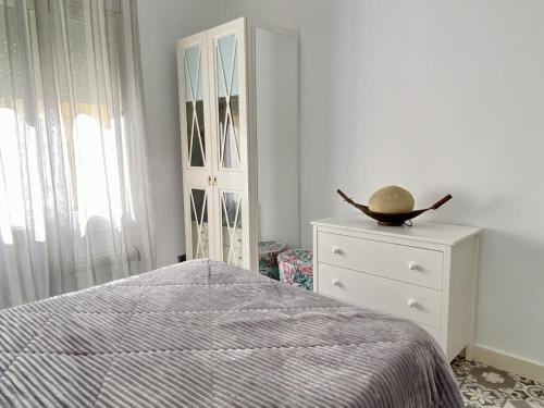 a bedroom with a bed and a dresser at Reconnectar Malgrat de Mar Emili in Malgrat de Mar