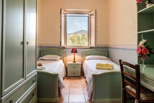 a bedroom with two beds and a window at Villa Filippa in Nicosia