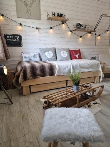 a bedroom with two beds and a table and lights at Studio rénové avec terrasse, parking , proche pistes,Villard de Lans in Villard-de-Lans