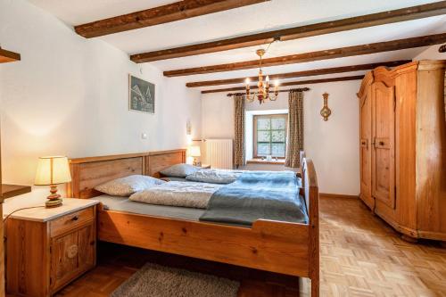 a bedroom with a large wooden bed with blue sheets at Ferien Alm Alfret in Herrischried