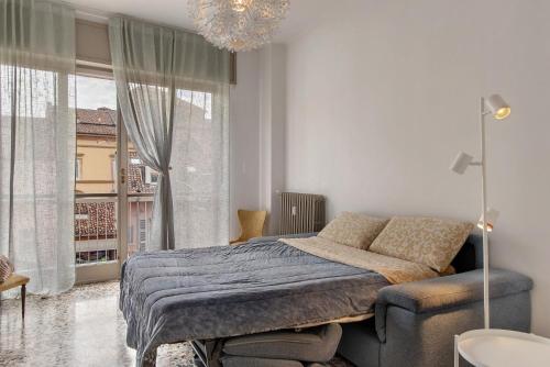a bedroom with a bed and a large window at De Rolandis in Asti