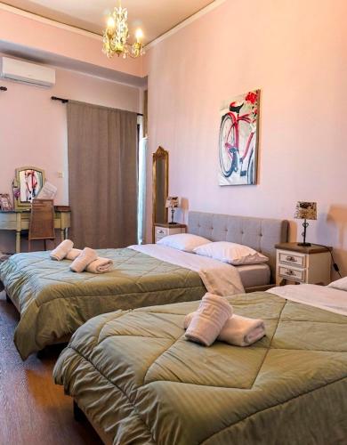 a bedroom with two beds with towels on them at Boutique Florence in Ermoupoli
