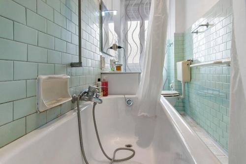 a bathroom with a bath tub and a sink at De Rolandis in Asti