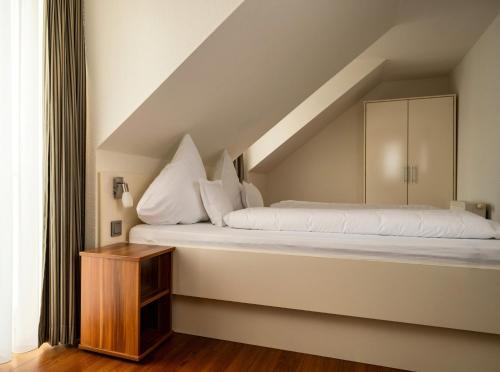 a bed in a room with a staircase at Ferienhaus Jümmers - Sönke in Horumersiel