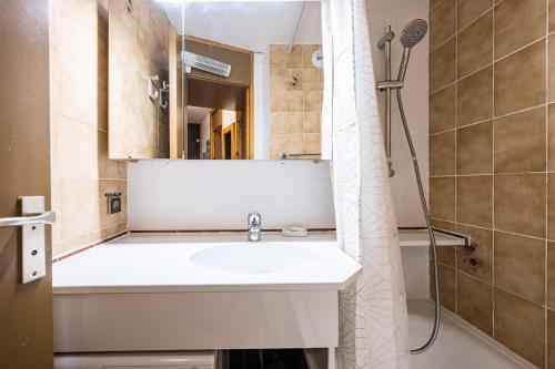 a bathroom with a sink and a mirror at Appartement 46 - Les Coches in La Plagne Tarentaise