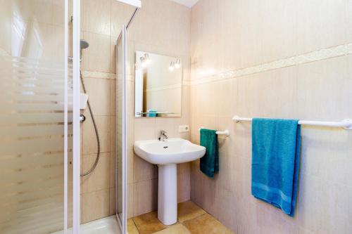a bathroom with a sink and a shower at Casa Antonio Invierno in Cala Llombards