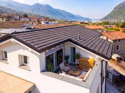 a roof of a house with mountains in the background at PENTHOUSE ISEO LAKE VIEW - Free Wi-Fi and Private Parking Included in Sale Marasino