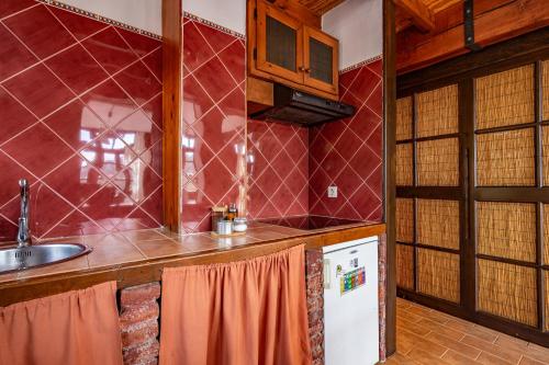 a kitchen with a sink and a refrigerator at Casa Florenta G3 in Cangas de Onís