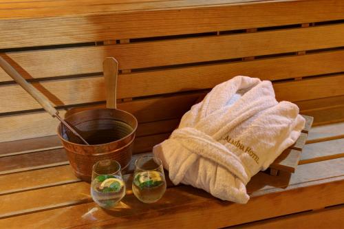 a towel and two glasses on a table in a sauna at Almina Guest House in Istanbul