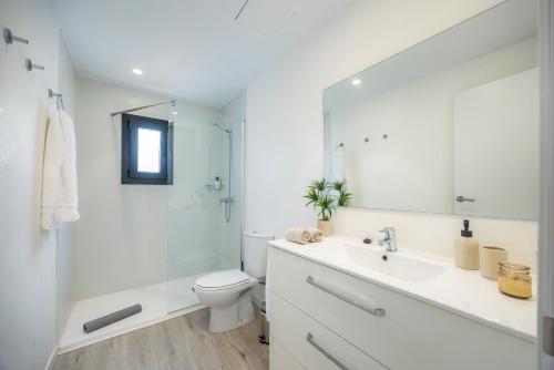 a bathroom with a sink and a toilet and a shower at White suites 2 in Cala d´Or