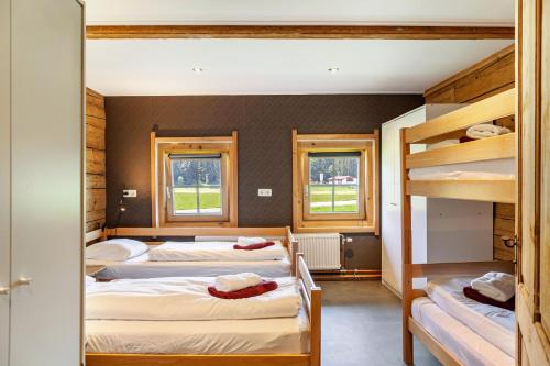 two bunk beds in a room with windows at The Farm in Westendorf