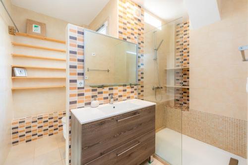 a bathroom with a sink and a shower at Villa Sol in Cala Figuera