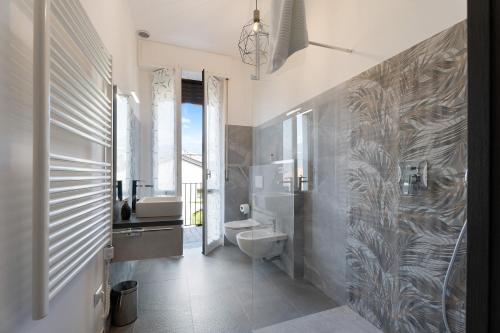 a bathroom with a toilet and a sink at Mansarda Vialba in Germignaga