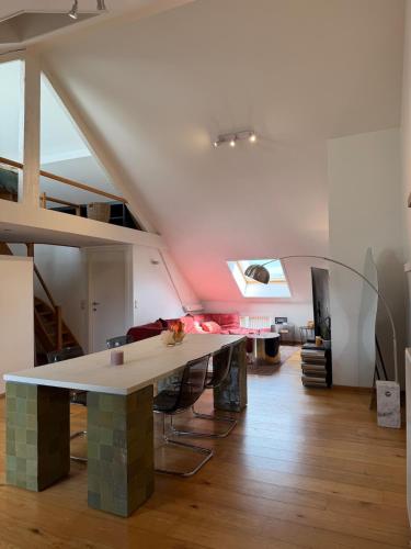 a living room with a table in the middle of a room at Cosy Studio in Mechelen by Studio Pila in Mechelen