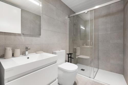a bathroom with a toilet and a sink and a shower at Horus 054 in Torre del Mar