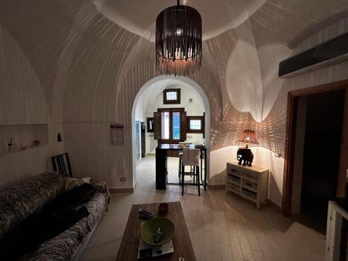 a living room with a couch and a table at Dammuso Cristoforo Colombo in Pantelleria