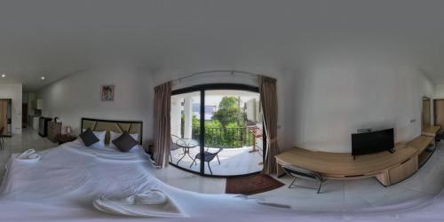 a bedroom with a large bed and a balcony at Bonny Hotel 4 Floors No Elevator in Lamai