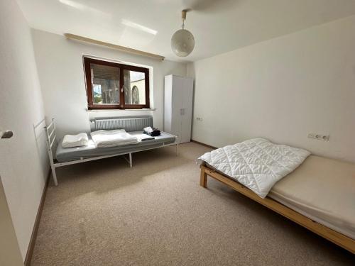 a bedroom with a bed and a window at Haus der Monteure in Stadtbergen