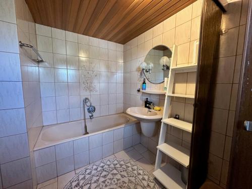 a bathroom with a bath tub and a sink at Haus der Monteure in Stadtbergen