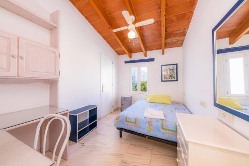 a bedroom with a bed in a kitchen with a ceiling at Can Blau in Portocolom