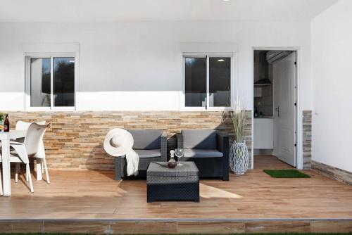 a living room with a couch and chairs and a table at Zahora Qg in Barbate