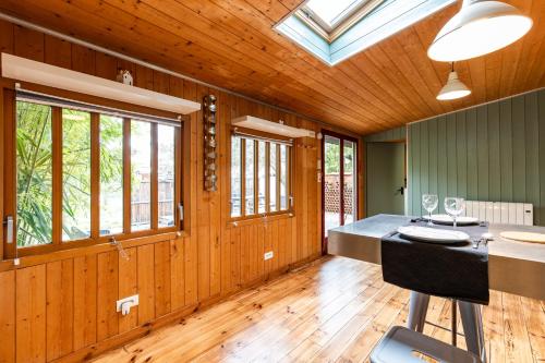 a room with wooden walls and a skylight at La Cabane d'Ana in Bordeaux