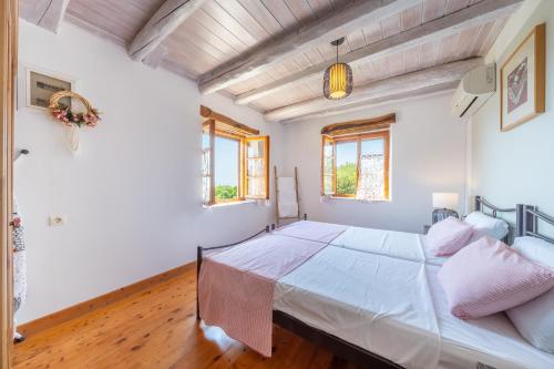 a bedroom with a large bed in a room at Villa Iremia Antipaxos in Antipaxos
