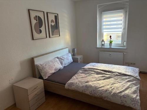 a bedroom with a bed and a window at Wohnung Weida 2 in Riesa