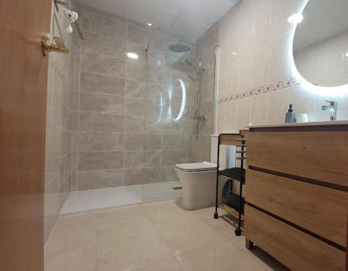 a bathroom with a shower with a toilet and a sink at Montserrat in Miami Platja