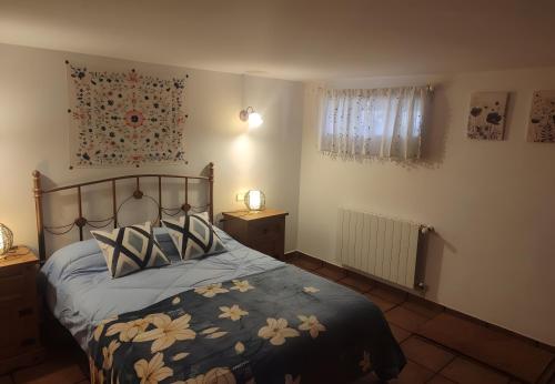 a bedroom with a bed with a blue comforter at Agroturismo El Serrano in Moratalla
