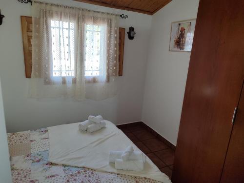 a bedroom with a bed with two towels on it at Agroturismo El Serrano in Moratalla