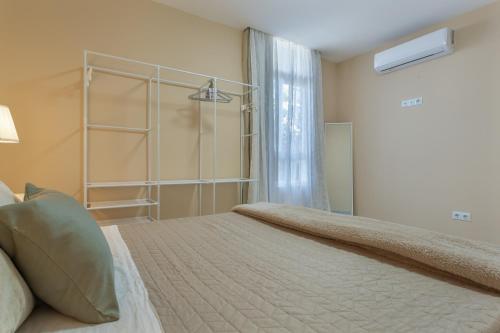 a bedroom with a large bed and a window at Cala Sunrise in Los Realejos