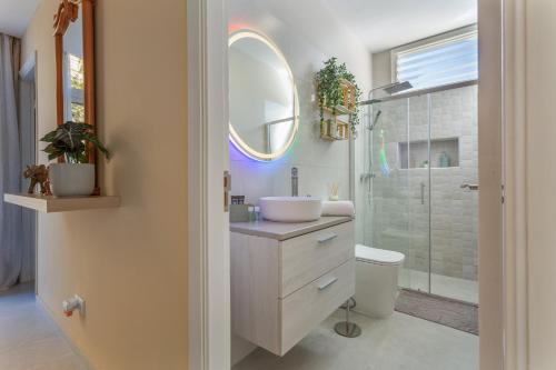 a bathroom with a sink and a toilet and a mirror at Cala Sunrise in Los Realejos