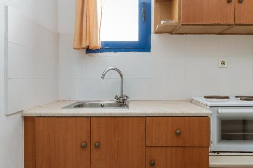 a kitchen with a sink and a stove at Perasma Studios 7 in Kipri