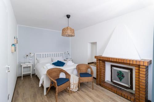 a bedroom with a bed and a fireplace at Bed and breakfast Biancalana in Petritoli
