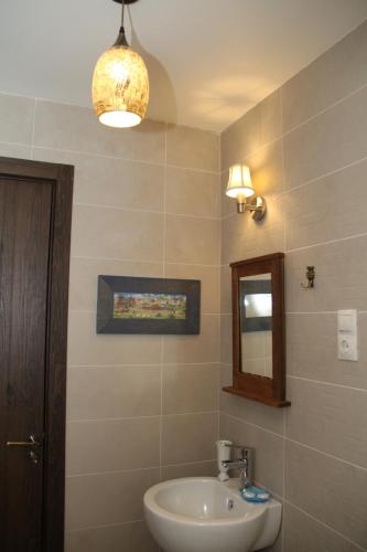 a bathroom with a sink and a mirror at Hotel Delisi in Tbilisi City