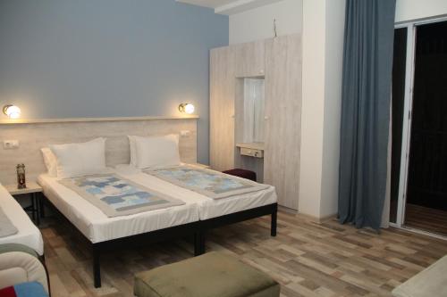a bedroom with a large bed in a room at Hotel Delisi in Tbilisi City
