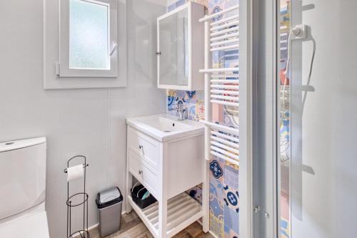 a small kitchen with a refrigerator and a sink at Gite Gariotte in Salignac Eyvigues