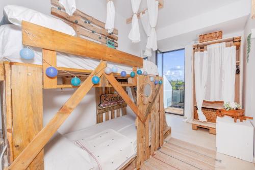 a bunk bed in a room with a window at Sa Perdiu 14 Menorca in Cala Santandria