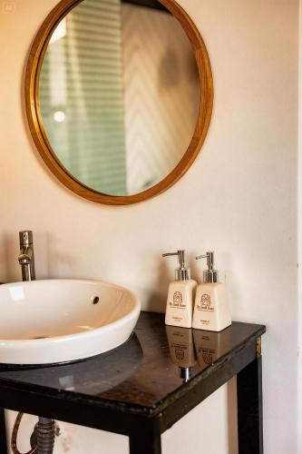 a bathroom with a sink and a mirror at BeYouth Hotel Dalat Valley View in Da Lat