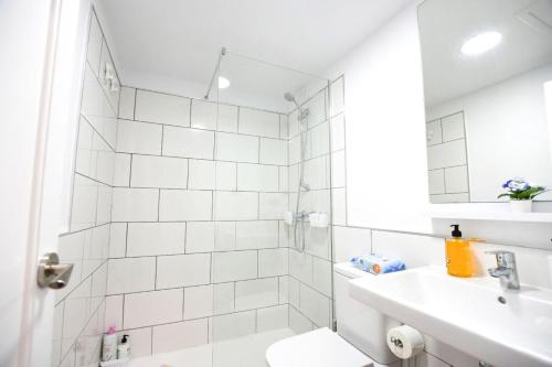 a white bathroom with a sink and a toilet at Coral Bliss-Oasis Duna in Corralejo
