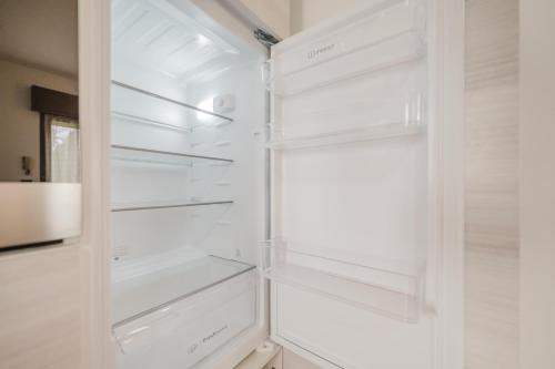 a white refrigerator with its doors open in a kitchen at La Fenice Private Gardent Free in Rivoli Veronese