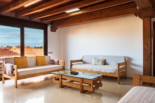 a living room with a couch and a table at La Chirumba in Aldeatejada