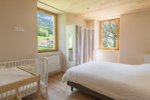 a bedroom with a large bed and a window at Gîte Le Chalimont in Saint-Julien-en-Vercors