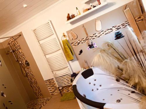 a bathroom with a large white tub in a room at Pension Nazli Elmshorn in Elmshorn