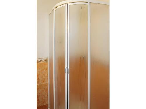 a shower with a glass door in a bathroom at Peña Yerga in Hospital