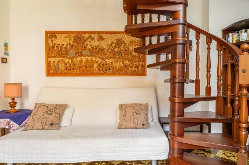 a room with a staircase with a bed and a rug at Casa Florio in Taormina