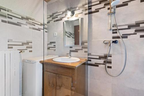 a bathroom with a sink and a shower at Gîte de La Séoube in Campan